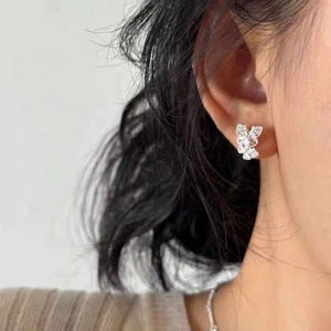 Elegant S925 sterling silver butterfly stud earrings worn by a model in a close-up view