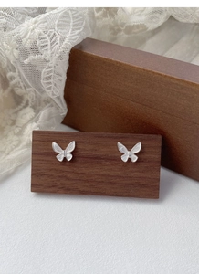Close-up of S925 sterling silver butterfly stud earrings with fine brushed texture