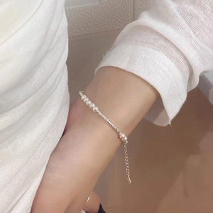 Elegant S925 sterling silver pearl bracelet featuring delicate beads on a woman's wrist
