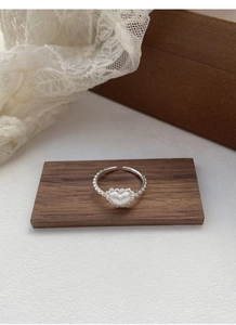 Detail of S925 sterling silver ring with matte heart and beaded adjustable band