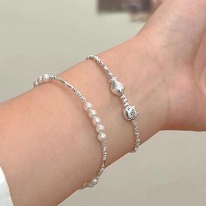 S925 sterling silver pearl bracelet set featuring cat and fish charms on a female wrist