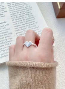 Macro detail of S925 sterling silver origami heart ring with brushed matte texture finish