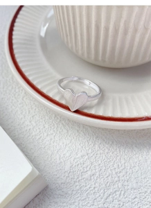 Detailed view of S925 sterling silver origami heart ring with brushed metal texture