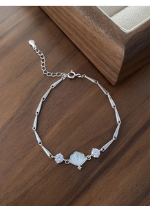 Detailed macro view of S925 sterling silver bamboo chain bracelet with white mother-of-pearl