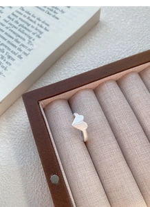 Close-up of minimalist S925 silver origami heart ring with matte brushed metal texture