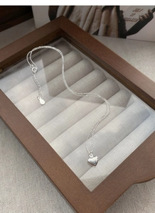 Close-up of S925 sterling silver heart pendant on a bead chain in a gift box