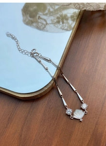 Detailed view of S925 sterling silver bamboo bracelet with a white fan shell pendant