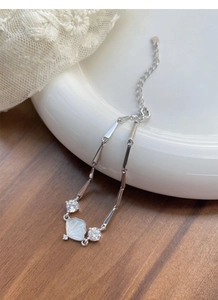 Detail of S925 sterling silver bamboo bracelet with white mother-of-pearl and zircons