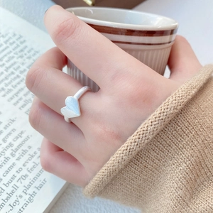 Minimalist S925 sterling silver heart ring with matte brushed finish worn by a model