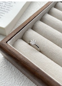 Close-up of S925 sterling silver snowflake ring with sparkling zircon stones in a jewelry box