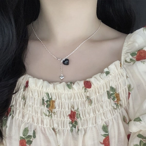 Elegant S925 sterling silver necklace featuring a black heart pendant and silver tassel