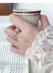 Close-up of S925 sterling silver butterfly ring with sparkling zircon inlays on hand