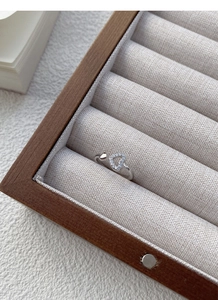 Detail of S925 sterling silver open ring with polished heart and sparkling cubic zirconia pavé