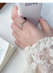Detailed close-up of a sterling silver butterfly ring featuring sparkling pavé crystals