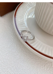 Detail of S925 sterling silver open ring featuring hollow heart with pavé set crystals
