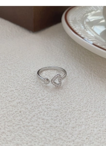 Close-up of S925 sterling silver ring with hollow pavé heart and smooth silver finish