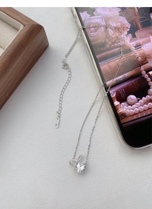 Detailed view of S925 sterling silver bow heart necklace with sparkling zircon stone