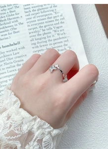 Detail of S925 silver butterfly ring with cubic zirconia inlay and open design