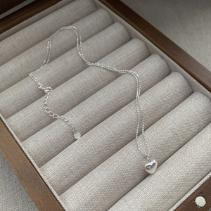 Minimalist S925 sterling silver heart pendant necklace with elegant beads on a jewelry box