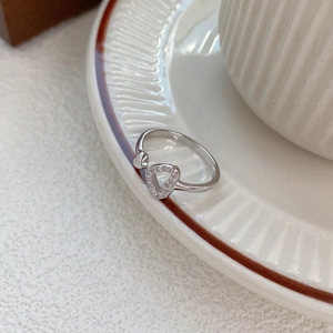 Elegant S925 sterling silver ring with hollow heart-shaped diamond setting on a tray