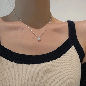 Minimalist S925 sterling silver heart bead necklace worn on model for casual look