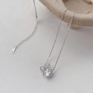 Elegant S925 sterling silver heart necklace with a sparkling bow pendant for women