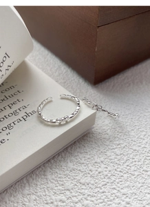 Detail shot of S925 sterling silver bow rings with visible hallmark on open band