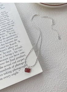 Detailed macro view of S925 silver rice bead chain with a rectangle strawberry crystal pendant