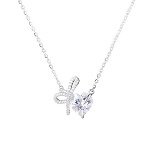 S925 sterling silver bow and heart necklace with sparkling crystals on white background