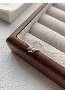 Macro detail of S925 sterling silver hollow flower ring with polished finish