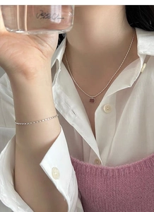 Close-up of S925 sterling silver necklace and bracelet set with red strawberry quartz