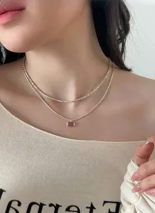 Detail of S925 silver layered necklace featuring a rectangular strawberry crystal pendant