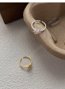 Detailed close-up of S925 sterling silver open rings with woven knot and floral designs