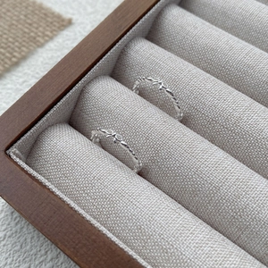 Elegant S925 sterling silver bow ring with beaded band design in a wooden jewelry box