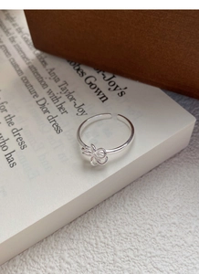 Macro view of adjustable S925 sterling silver ring with a detailed 3D bow design