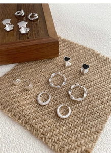 Detailed view of S925 sterling silver earring set including star and heart studs