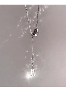 Detailed view of S925 silver lucky bean pendant with engraved rectangular tag