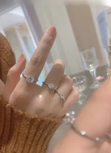 Detailed view of three 925 sterling silver rings with moissanite six-prong setting