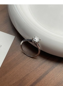 Detailed view of 1 carat moissanite ring with classic six-prong setting on silver band