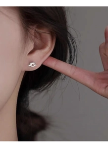 Close-up of S925 sterling silver knotted stud earring worn on a model's ear lobe