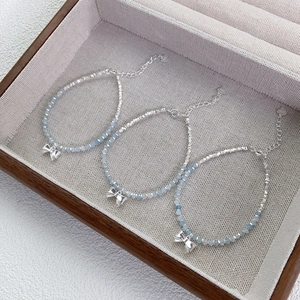 Elegant S925 sterling silver bow bracelet featuring light blue aquamarine gemstone beads