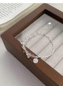 Detailed macro of S925 silver bracelet with white crystals and lucky charm tag