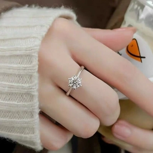 Classic six-prong moissanite solitaire ring in sterling silver on hand for engagement