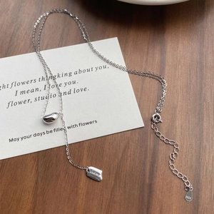 Minimalist S925 sterling silver necklace featuring a lucky square tag and silver bean pendant