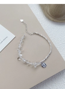 Detail view of S925 silver bracelet with clear crystals and Good Fortune round charm