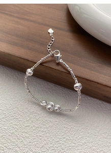 Macro shot of S925 sterling silver beaded bracelet showing lobster clasp and heart charm