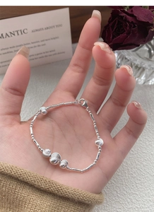 Detailed macro view of S925 sterling silver beaded bracelet with bamboo tube accents