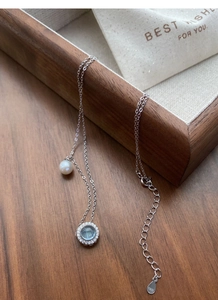 Detail of S925 silver necklace with blue gemstone, single pearl and hallmark tag