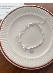 Detail of S925 sterling silver bracelet with irregular crystal stones on ceramic plate
