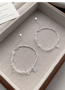 Macro detail of S925 sterling silver bracelet with irregular crystals and heart pendant